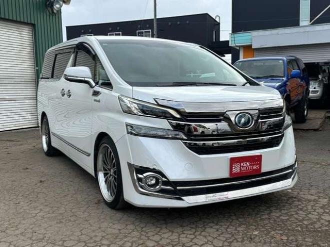 ヴェルファイアハイブリッド 2.5 V E-Four 4WD　社外アルミ　オートミラー　ETC　ドライブレコーダー　ローダウン　ワンオーナー　両側電動スライドドア　パワステ　パワーウィンドウ　ベージュ革シート　純正ナビ　バックカメラ　ABS　キーレスエントリー 2500