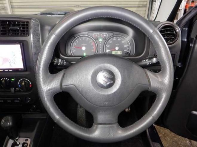 ジムニーワイルドウインド 4WD　本州仕入・ナビ・フルセグTV・キーレス・フォグランプ・シートヒーター・ミラーヒーター・ルーフレール・ターボ・社外AW・ライトレベライザー・電動格納ミラー・DVD再生・JAOSマッドガード 660