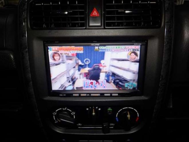 ジムニーワイルドウインド 4WD　本州仕入・ナビ・フルセグTV・キーレス・フォグランプ・シートヒーター・ミラーヒーター・ルーフレール・ターボ・社外AW・ライトレベライザー・電動格納ミラー・DVD再生・JAOSマッドガード 660